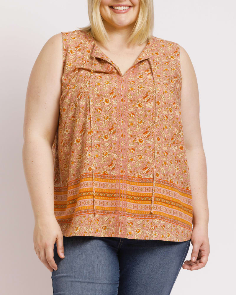 Front of a model wearing a size 1X Maliah Sleeveless Floral Top in O215 CORAL by Daniel Rainn. | dia_product_style_image_id:297428
